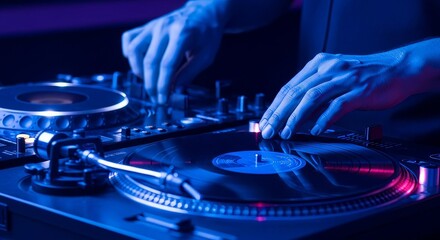 DJ operating a turntable and mixer illuminated in blue and pink lighting showcasing hands manipulating equipment