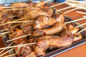 Bacem of chicken head satay, side dishes in angkringan, indonesian javanese yogyakarta nasi kucing