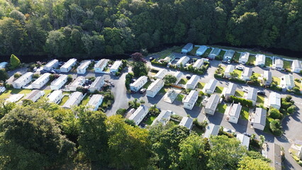 Drone panorama of seaside caravan park with holiday homes and lush green spaces – perfect for...