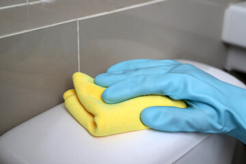 housekeeper uses a microfiber cloth to clean the bathroom.