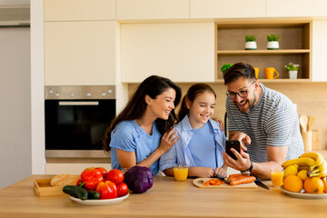 Family enjoying quality time in the kitchen while preparing a healthy meal