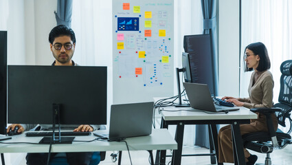 asian woman  and Indian man Developer team working  about programming software data online at office