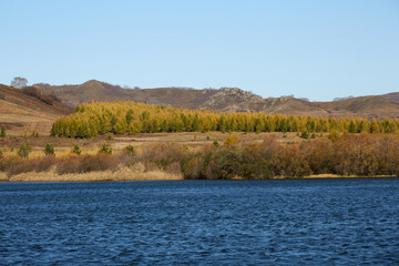 Lakeside autumn scenery and mountain forest landscape at Ulan Butong, China