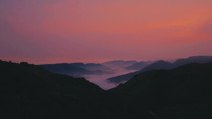 Aerial Drone Reveal and Approach Shot of Misty Mountains at Sunrise - Powered by Adobe