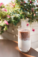 Close-up of an iced mocha coffee on a table at a street cafe in summer.