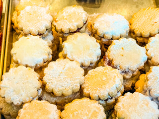 Shortbread cookies with jam filling and powdered sugar. Dessert, sweetness and indulgence in homemade bakery.