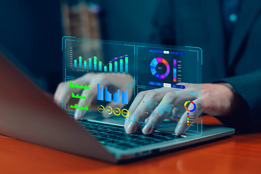 Businessman working on laptop with futuristic digital dashboard displaying analytics, charts, graphs and statistics for business analytics, big data, financial analysis.
