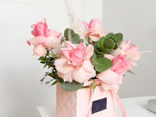Bouquet of pink roses with greenery. Elegance, romance, and floral expression of love and beauty in decorative arrangement.