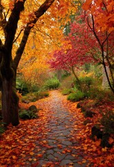 A pathway winds through a vibrant autumn garden, framed by towering trees ablaze with orange, red, and yellow foliage. The path is constructed of weathered, moss-covered stones, leading into a dark