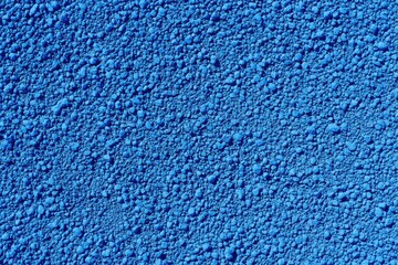 Close-up of a vibrant blue granular surface