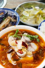 angle view fast food of spicy boiled fish and vegetable and eggplant at vertical composition
