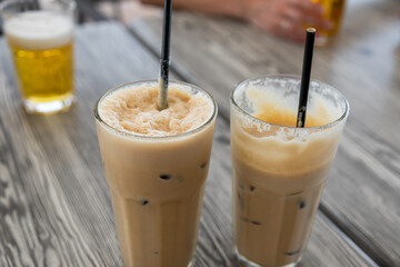 Glasses of iced coffee on a wooden table in Marsaxlokk.