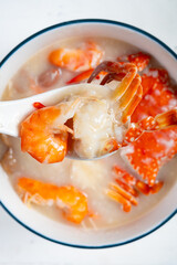 top view fresh seafood porridge with shrimps and crabs at vertical composition