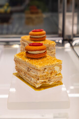 elegant layered pastries topped with colorful macaroon