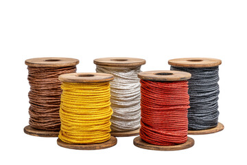 A row of five different colored spools of thread. The spools are yellow, white, red, brown, and black