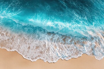 High-angle view of turquoise waves crashing on beige sand