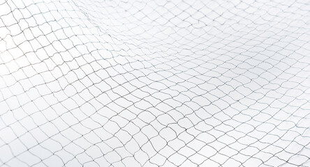 Black net mesh pattern on white background, minimal abstract texture for safety, security, sport, fence, and barrier design, suitable for creative backgrounds and graphic design projects.