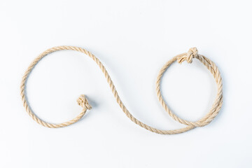 Closeup of natural rope with knots arranged on white background, concept for strength, security, nautical, construction, and abstract design, perfect for creative projects and backgrounds.
