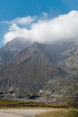 Misty mountain peaks partially obscured by clouds creating moody alpine atmosphere