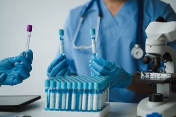 Doctor comparing blood samples in test tubes during medical research
