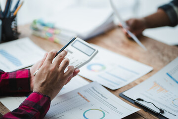 Businessman calculating and analyzing financial data at office desk