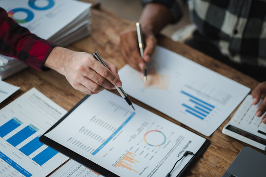 Business team discussing financial data and using calculator for analyzing sales data and business strategy