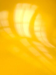 abstract yellow orange variegated background with window pane shadows 