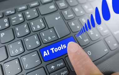 AI tools key on a blue keyboard. Finger pressing key