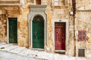 Fototapeta premium Old colorful doors on a narrow street in Valletta, Malta