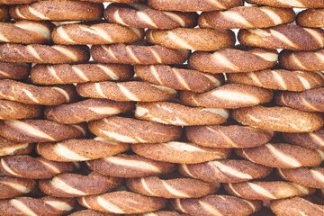 Freshly baked turkish simit stacked high at a market stall