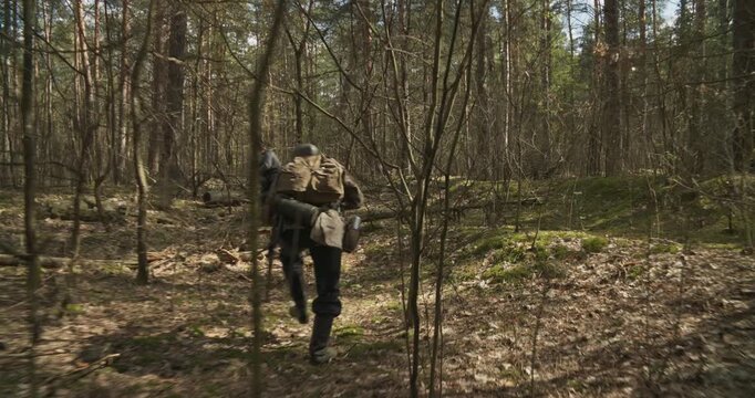 Group Of Soldiers With Carabines Mauser 98k Sneak Carefully Through Forest. Danger Of Sudden Attack. Wermacht Military Uniform. Reenactors Dressed As German Infantry Soldiers Search Ambush In Forest