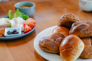Breakfast with bread rolls and Japanese Western style side dishes
