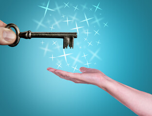Hand supports the Key. Success in business concept