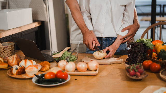 Couple preparing healthy meal together in kitchen