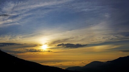 Colorful sunrise over Dieng Plateau mountain valley with mist for travel wallpaper background
