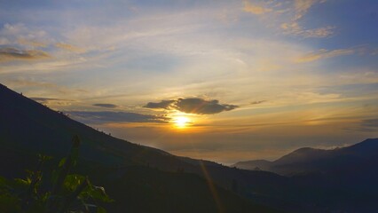 Fototapeta premium Colorful sunrise over Dieng Plateau mountain valley with mist for travel wallpaper background 
