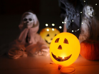 Orange Jack-o-Lantern Balloon in Focus on Dark Background