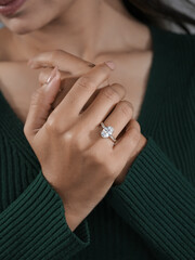 woman's elegant finger ring with a white diamond