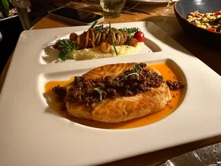 A perfectly grilled salmon fillet served with roasted vegetables