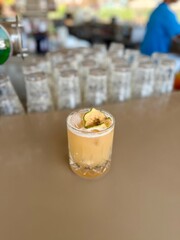 lcoholic cocktail with vodka, pineapple juice, mango, liquor, ice. Long drink or summer cold mocktail. Tropical dark background with palm leaves and exotic fruits