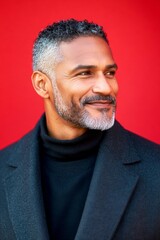 Obraz premium A happy and poised man radiating charm. A cheerful and glowing gentleman with a relaxed demeanor. A man with a natural glow and soft masculinity. A joyful male captured in a professional portra.