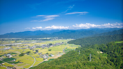 View of Toyama Bay, the Kurobe River alluvial fan, the Hokuriku Shinkansen, and farms from Kurobe City in eastern Toyama Prefecture, Japan