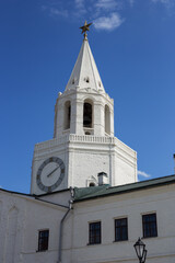 View of white Spasskaya Tower adorned with vintage clock in a historic location Kazan Kremlin.