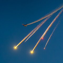Bucharest Air Show. Evening aviation show with spectacular moments against evening sky. Romanian air show under clear moon, fireworks and flag of Romania moments.