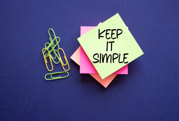 Keep it Simple symbol. Concept words Keep it Simple on sticky notes. Beautiful deep blue...