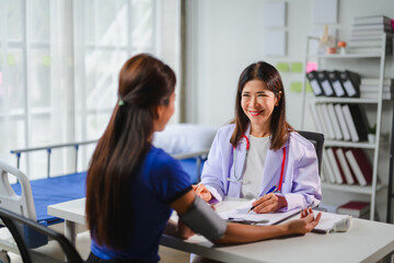 Doctor measuring blood pressure of patient in hospital room