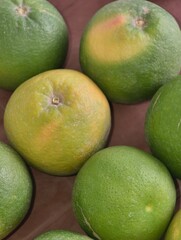 Group of limes with varying degrees of ripeness and color variation