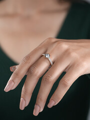 A woman's elegant finger ring with a white diamond