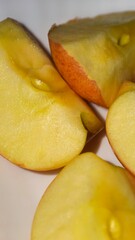 Close up of fresh apple slices with a drop of juice on the surface