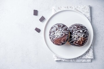 Chocolate and nuts donuts in a plate